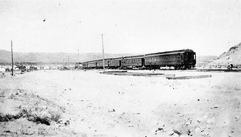 A passenger train stopped on the tracks at the edge of Beatty in 1906