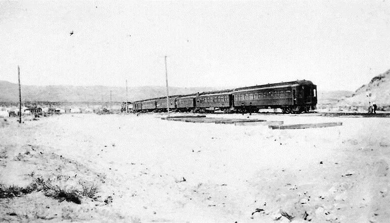 A passenger train stopped on the tracks at the edge of Beatty in 1906